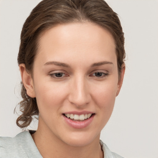 Joyful white young-adult female with medium  brown hair and grey eyes