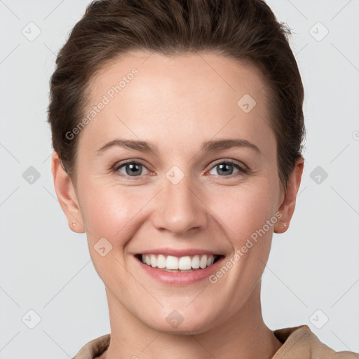 Joyful white young-adult female with short  brown hair and grey eyes