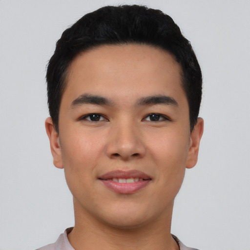 Joyful asian young-adult male with short  black hair and brown eyes