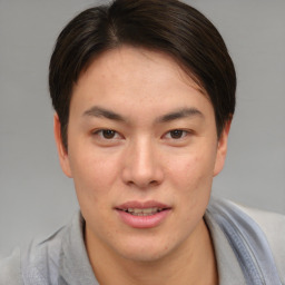 Joyful asian young-adult male with short  brown hair and brown eyes