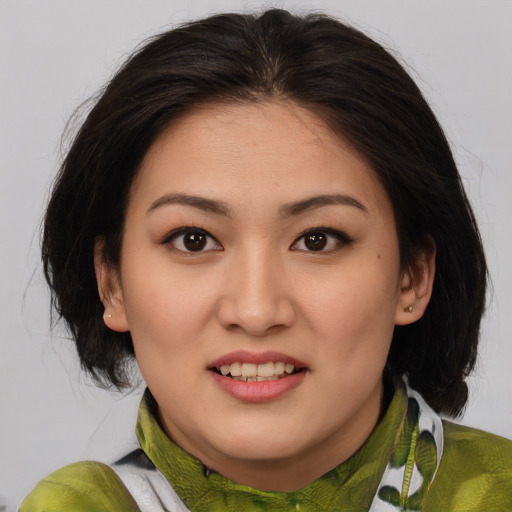 Joyful asian young-adult female with medium  brown hair and brown eyes