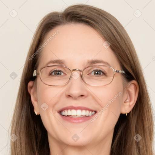 Joyful white adult female with long  brown hair and grey eyes