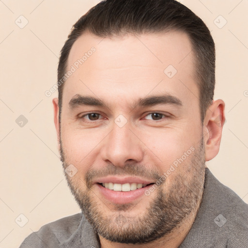 Joyful white young-adult male with short  brown hair and brown eyes