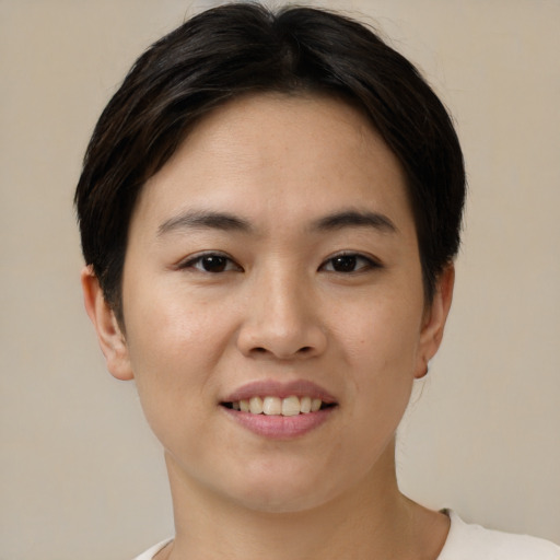 Joyful asian young-adult female with short  brown hair and brown eyes
