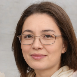 Joyful white adult female with medium  brown hair and brown eyes