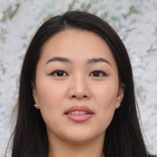 Joyful asian young-adult female with long  brown hair and brown eyes