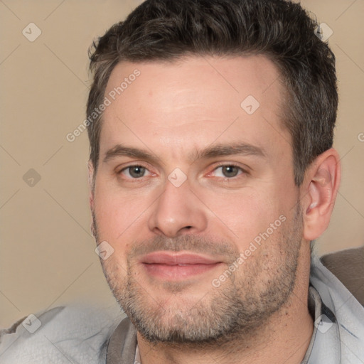 Joyful white adult male with short  brown hair and brown eyes