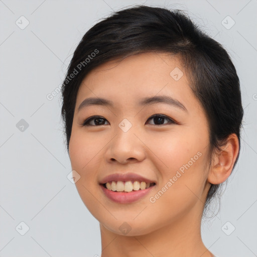 Joyful asian young-adult female with long  brown hair and brown eyes