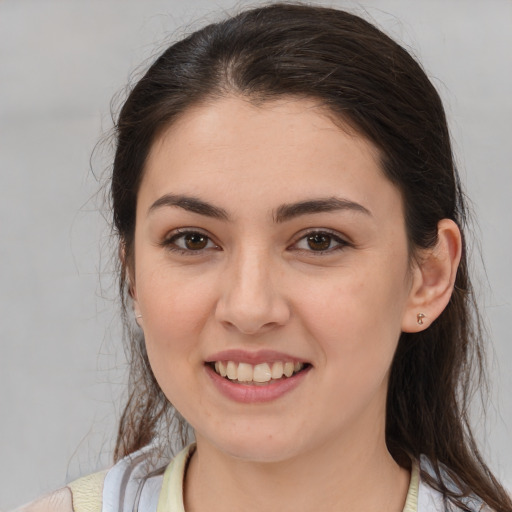 Joyful white young-adult female with medium  brown hair and brown eyes