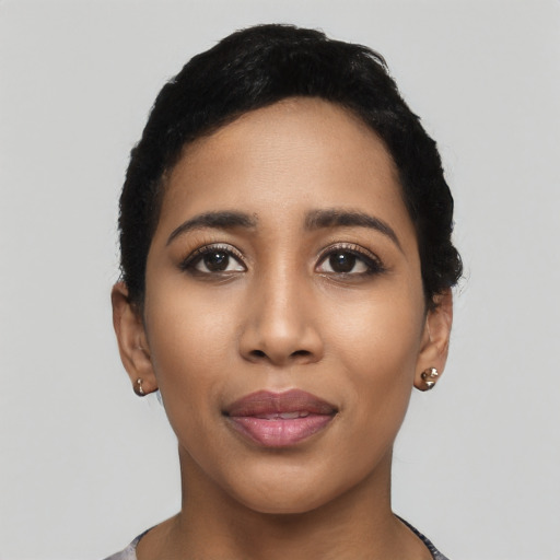 Joyful latino young-adult female with short  black hair and brown eyes