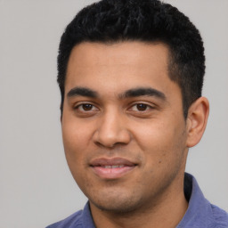 Joyful latino young-adult male with short  black hair and brown eyes