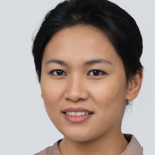 Joyful asian young-adult female with short  black hair and brown eyes