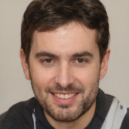 Joyful white adult male with short  brown hair and brown eyes