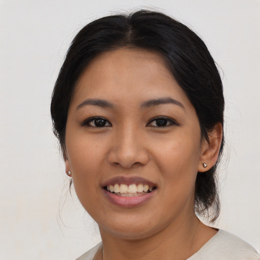 Joyful asian young-adult female with medium  black hair and brown eyes