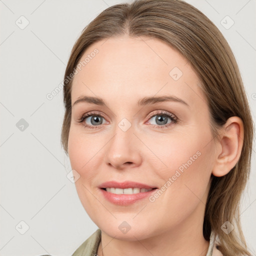 Joyful white young-adult female with medium  brown hair and grey eyes