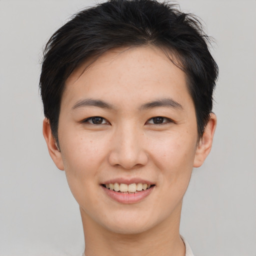 Joyful asian young-adult female with short  brown hair and brown eyes