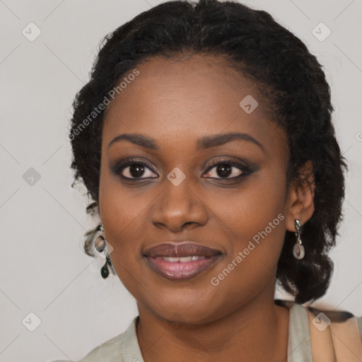 Joyful black young-adult female with long  black hair and brown eyes