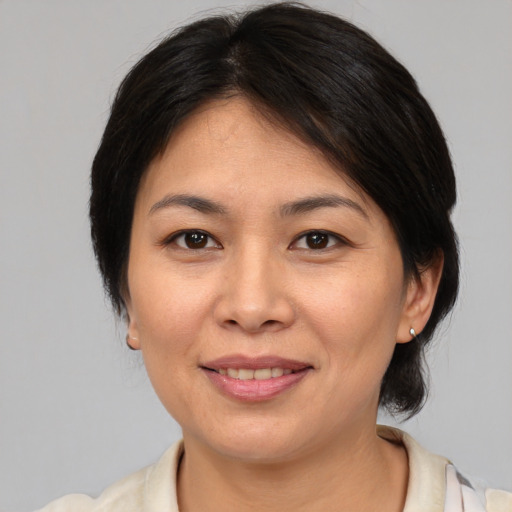 Joyful white adult female with medium  brown hair and brown eyes