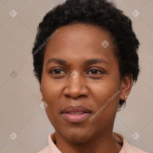 Joyful black young-adult female with short  black hair and brown eyes