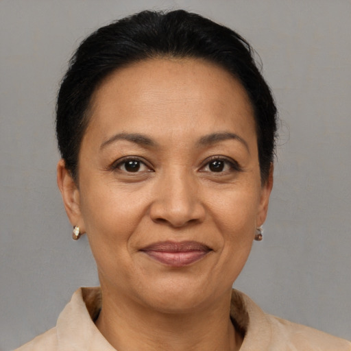 Joyful latino adult female with short  brown hair and brown eyes