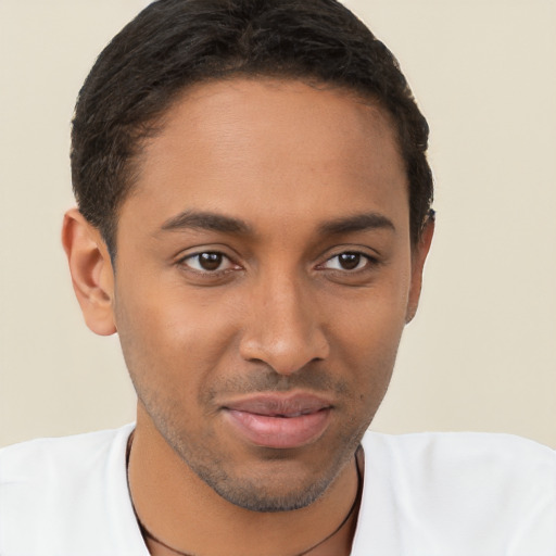 Joyful black young-adult male with short  brown hair and brown eyes