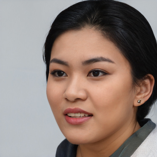 Joyful asian young-adult female with medium  black hair and brown eyes