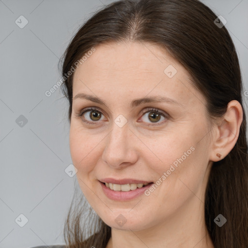 Joyful white adult female with long  brown hair and brown eyes