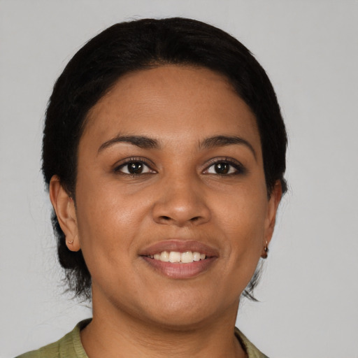 Joyful latino young-adult female with short  brown hair and brown eyes