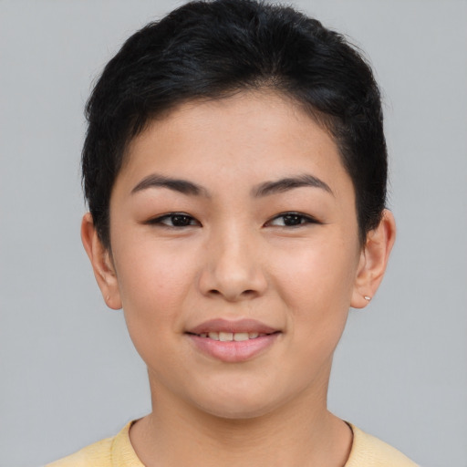 Joyful asian young-adult female with short  brown hair and brown eyes