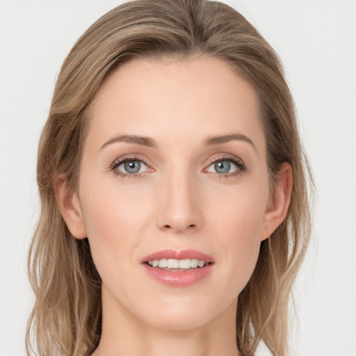 Joyful white young-adult female with long  brown hair and grey eyes