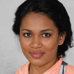 Joyful black young-adult female with medium  brown hair and brown eyes