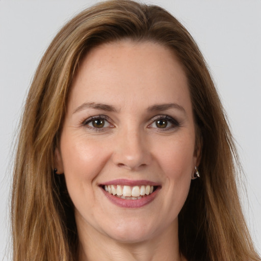 Joyful white young-adult female with long  brown hair and green eyes