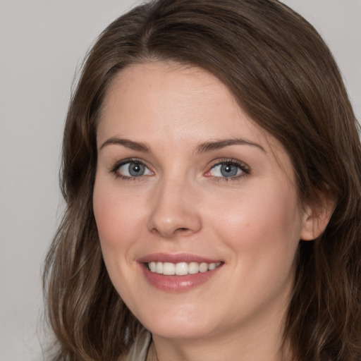 Joyful white young-adult female with medium  brown hair and blue eyes