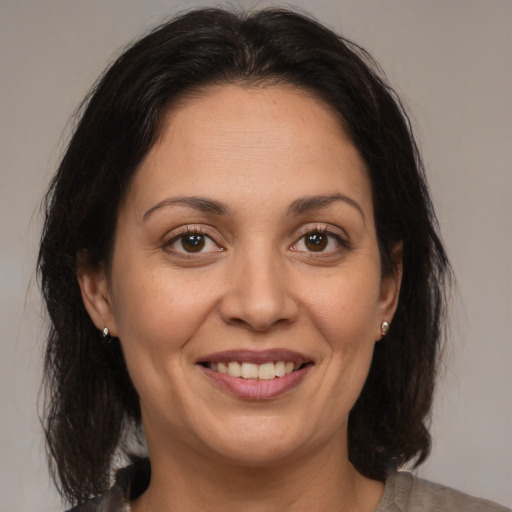 Joyful white adult female with medium  brown hair and brown eyes