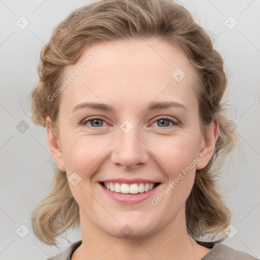 Joyful white young-adult female with medium  brown hair and blue eyes