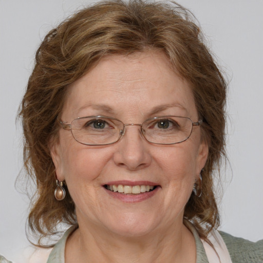 Joyful white middle-aged female with medium  brown hair and blue eyes