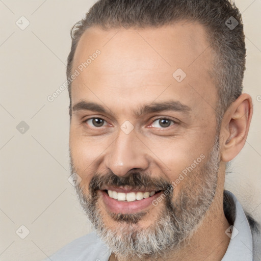 Joyful white adult male with short  brown hair and brown eyes