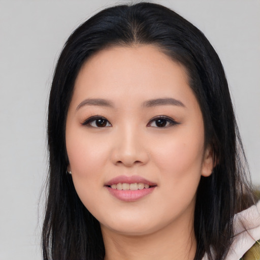 Joyful asian young-adult female with long  black hair and brown eyes
