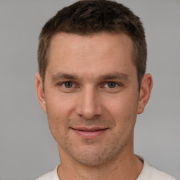 Joyful white adult male with short  brown hair and brown eyes