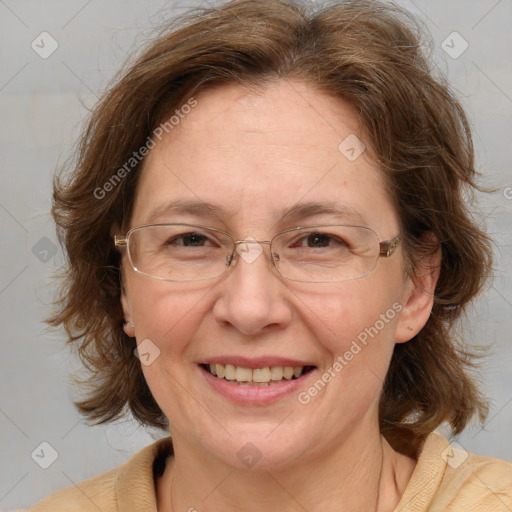 Joyful white adult female with medium  brown hair and blue eyes