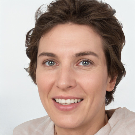 Joyful white young-adult female with medium  brown hair and green eyes