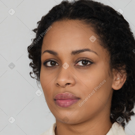 Joyful black young-adult female with medium  black hair and brown eyes