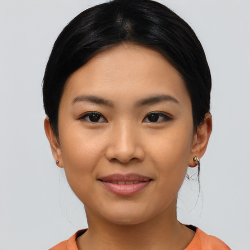 Joyful latino young-adult female with short  black hair and brown eyes