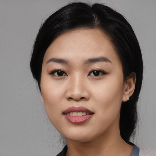 Joyful asian young-adult female with medium  black hair and brown eyes