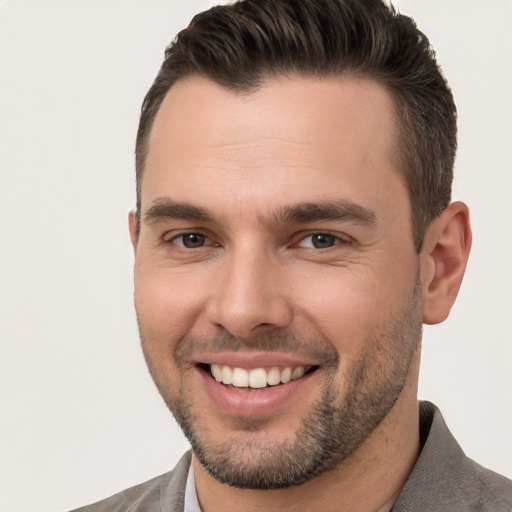 Joyful white young-adult male with short  brown hair and brown eyes