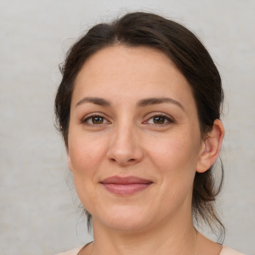 Joyful white adult female with medium  brown hair and brown eyes