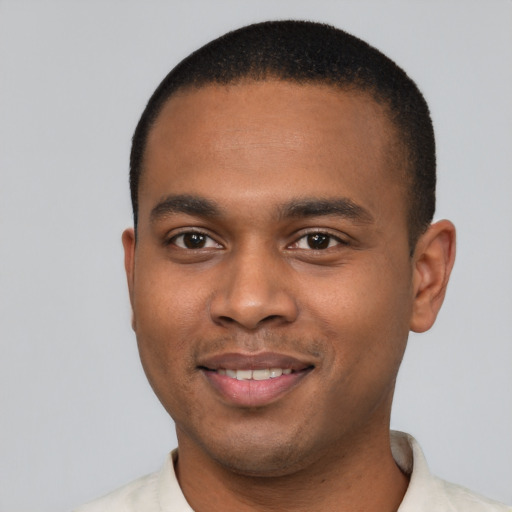 Joyful black young-adult male with short  brown hair and brown eyes