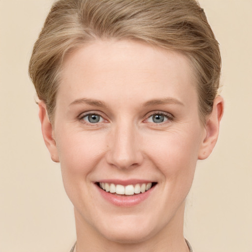 Joyful white young-adult female with short  brown hair and grey eyes