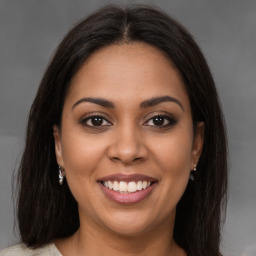 Joyful latino young-adult female with medium  brown hair and brown eyes