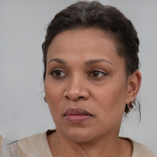 Joyful black adult female with short  brown hair and brown eyes